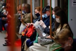 People wearing face masks to help curb the spread of the coronavirus ride a subway car in Moscow, Russia, June 10, 2021.
