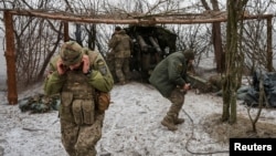 FILE - Ukrainian servicemen fire a D-20 howitzer toward Russian troops, amid Russia's attacks on Ukraine, near the front line town of Pokrovsk in Ukraine's Donetsk region, Feb. 6, 2025. (Radio Free Europe/Radio Liberty/Serhii Nuzhnenko via Reuters)