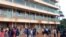 Parents and teachers gather near the scene of a stampede at the Kakamega primary school in Kakamega, Kenya, Feb. 3, 2020.