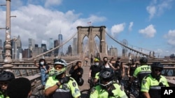 NYPD officers block the Brooklyn Bridge after a clash between officers and Black Lives Matter protesters, in New York, July 15, 2020.