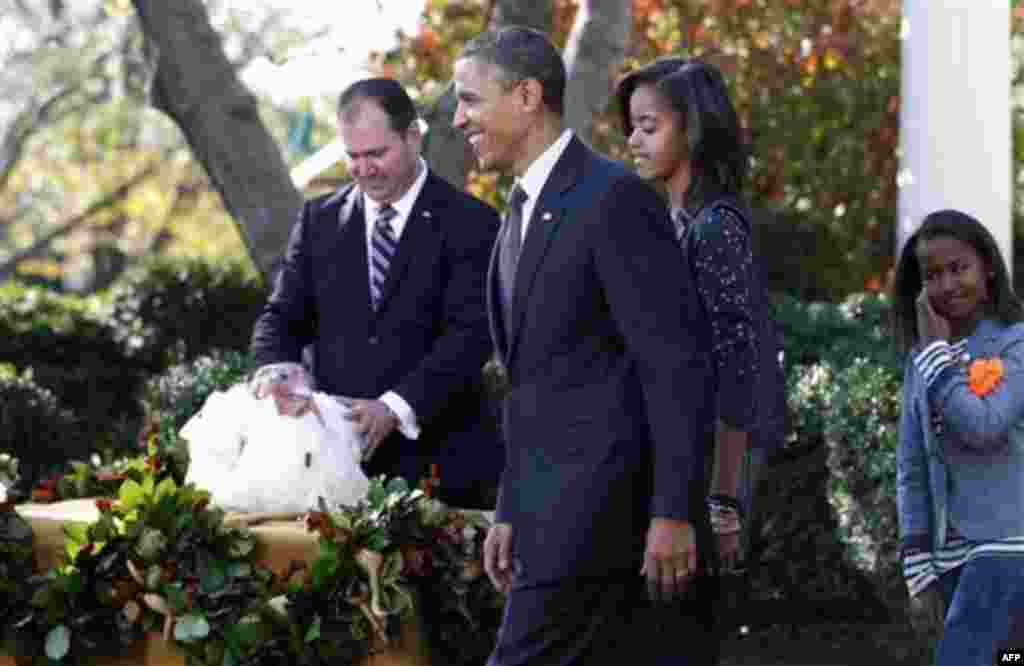 President Barack Obama, walks with daughters Malia Obama and Sasha Obama after he pardoned Apple, the National Thanksgiving Turkey, during a ceremony in the Rose Garden of the White House in Washington, Wednesday, Nov. 24, 2010. At rear is National Turkey