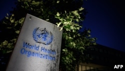 FILE - A sign of the World Health Organization (WHO) is seen at the headquarters in Geneva, May 29, 2020.