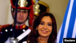 FILE - Former Argentine President Cristina Fernandez smiles during a ceremony on her last day in office at the Casa Rosada Presidential Palace in Buenos Aires, Argentina, Dec. 9, 2015. 