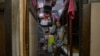 FILE - Kwok Kwai, 65, poses for a photo inside his subdivided flat in Hong Kong, Aug. 8, 2024. 