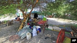 FILE: A man rests while waiting for a barge to continue his journey home from Kosti, Sudan, to his home back in South Sudan, September 21, 2011.