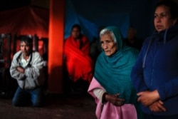 Mourners pray around the coffin of environmental activist Homero Gomez Gonzalez at his wake in Ocampo, Michoacan state, Mexico, Jan. 30, 2020. The cause of the anti-logging activist's death is under investigation.
