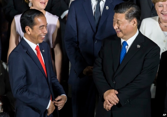 FILE - Indonesian President Joko Widodo, left, speaks to Chinese President Xi Jinping at the G-20 summit on June 28, 2019, in Osaka, Japan. During Widodo's time as president, China became Indonesia’s largest trading partner.