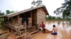 Kongvilay Inthavong and his wife Thongla clean up their house as the floodwaters start to recede in Sanamxay district, Attapeu province, Laos on Thursday, July 26, 2018. Authorities and the builder are investigating why a dam in southeastern Laos collapsed earlier this week, killing at least two dozen people and leaving over a hundred missing. (AP Photo/Hau Dinh)