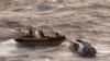 Navy sailors from HMAS Choules use an inflatable boat to rescue Lithuanian rower Aurimas Mockus, Monday, March 3, 2025