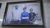 A picture hanging in Ko Ni's family home shows him and his wife (right) posing with Aung San Suu Kyi.