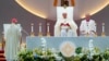 Pope Francis, seated left, presides over Mass at the SportsHub National Stadium in Singapore, Sept. 12, 2024.