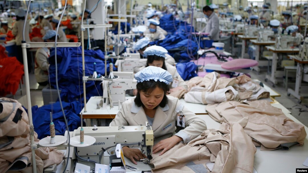 FILE - North Korean employees, shown in December 2013, sew in a South Korean-owned company at the Kaesong industrial park just north of the demilitarized zone. 