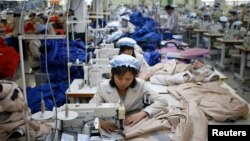 FILE - North Korean employees, shown in December 2013, sew in a South Korean-owned company at the Kaesong industrial park just north of the demilitarized zone. 