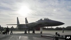 FILE - An F-15E Strike Eagle sits on the flightline at Royal Air Force Lakenheath, England, in October 2010.