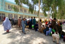 Internally displaced Afghans who fled their home due to fighting between the Taliban and Afghan security personnel, are seen at a camp in Daman district of Kandahar province south of Kabul, Afghanistan, Aug. 5, 2021.