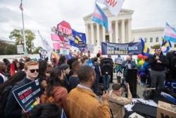 LGBT supporters gather in front of the U.S. Supreme Court, in Washington, Oct. 8, 2019.