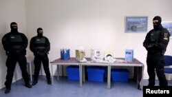 German customs enforcement officers pose with some of the cocaine seized in the northern port city of Hamburg, Feb. 24, 2021.