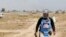 An Iraqi mine clearer working for Halo Trust, a non-profit organization specialized in mine removal, is pictured in an agricultural and industrial field near the Iraqi town of Baiji, Aug. 25, 2019.