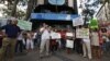 Demonstrators hold signs as they protest against what they say is abuse of the system by banks and the failure of the government to stop them, in front of the headquarters of Spain's center-right People's Party [Partido Popular] in Madrid, July 8, 2012.