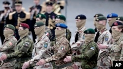 FILE - Soldiers from the European Task force Takuba march on the Champs-Elysees in Paris, Wednesday July 14, 2021. A European military task force fighting extremists in Mali has formally withdrawn from the West African country amid tensions with its ruling military junta. 