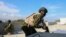 FILE - A Kenyan police officer, part of a UN-backed multinational force, runs to take cover from an exchange of gunfire between gangs and police at the Kenyan base in the Delmas neighborhood of Port-au-Prince, Haiti, Thursday, Dec. 5, 2024.