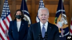 President Joe Biden speaks after meeting with leaders from Georgia's Asian-American and Pacific Islander community, March 19, 2021, at Emory University in Atlanta, as Vice President Kamala Harris listens.