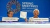 IMF Managing Director Christine Lagarde (R) holds up agenda papers as she attends a press briefing to open the IMF and World Bank's 2017 Annual Spring Meetings, with First Deputy David Lipton, in Washington, April 20, 2017. 