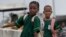 Young Nigerian school girls walk near a bus park. Often girls are forced to give up their educational aspirations (File Photo).