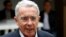 FILE - Colombia's former president Alvaro Uribe Velez speaks to the news media after casting his vote at a polling station, during the presidential election in Bogota, May 27, 2018.