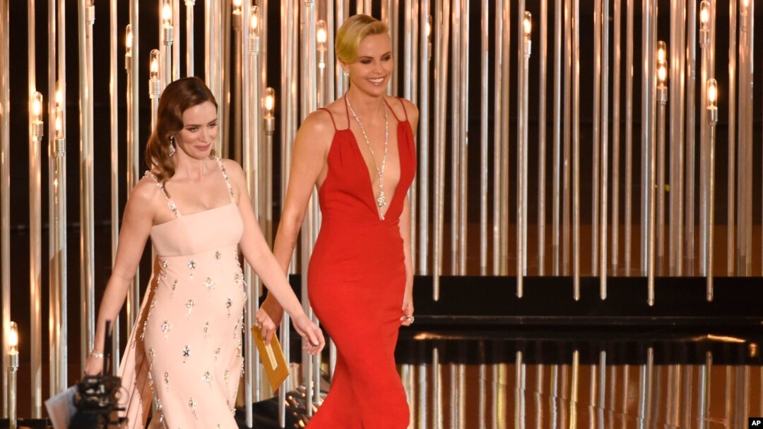 FILE - Emily Blunt, left, and Charlize Theron present an award at the Oscars in Los Angeles, Feb. 28, 2016. The actresses appear in "The Huntsman: Winter's War." 