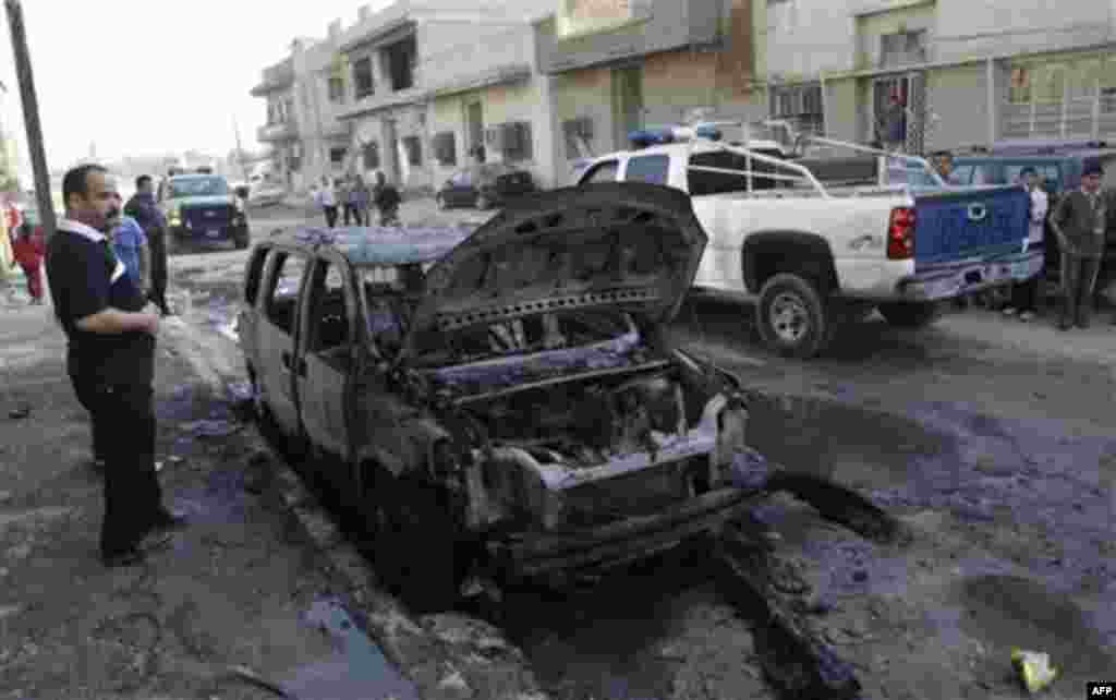 Security forces and people gather at the scene of a bomb attack in Baghdad, Iraq, Wednesday, Nov. 10, 2010. A string of bombings targeted Christian houses in Baghdad early Wednesday, killing and wounding several people, police said. (AP Photo/Khalid Moham