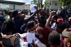 Migrants from Africa and Haiti try to enter the Siglo XXI immigrant detention center to request humanitarian visas, issued by the Mexican government, to cross the country toward the United States, in Tapachula, Mexico, June 27, 2019.