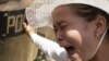 A Cambodian protester, right, from Boueng Kak lake, cries as she clashes with police officers in Phnom Penh, Cambodia, Tuesday, May 22, 2012. 