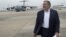 U.S. Secretary of Defense Leon Panetta walks across the tarmac as he transfers planes from a C-17 military aircraft to his Boeing E4-B prior to departing for San Francisco, California, Nov. 16, 2012.