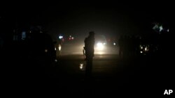 Afghan security forces patrol the site of an attack on an Afghan parliament member's house in western Kabul, Afghanistan, Dec. 21, 2016.