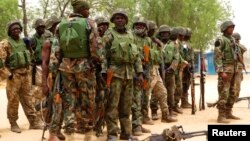 Soldiers stand during a parade in Baga village in the northeastern state of Borno May 13, 2013. 