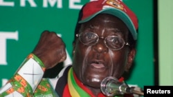 FILE: Zimbabwe's President Robert Mugabe gestures as he speaks to party supporters at the launch of his Presidential run-off campaign in the capital Harare May 25, 2008. 