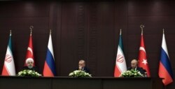 Turkish President Recep Tayyip Erdogan, center, Russia's President Vladimir Putin, right, and Iran's President Hassan Rouhani speak to the media at a news conference in Ankara, Turkey, Sept. 16, 2019.