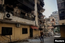 A man walks past a damaged building in the aftermath of the Israeli strikes, amid ongoing hostilities between Hezbollah and Israeli forces, in the Chiyah area of Dahiyeh, Beirut, Oct. 5, 2024.