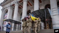 FILE - Fellow soldiers carry Petro Velykiy's coffin during a funeral, Nov. 27, 2024, at the theater in Chernyhiv, Ukraine, for the 48-year-old actor who was killed in a battle with Russian troops in the Kursk region. 