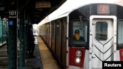 A New York City Transit worker drives a subway train in the Bronx borough of New York City, April 21, 2020.
