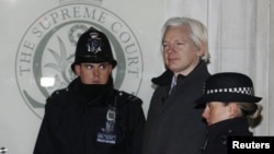 Julian Assange walked by two bobbies in to Supreme Court in London