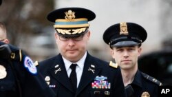 Army Lieutenant Colonel Alexander Vindman, a military officer at the National Security Council, center, arrives on Capitol Hill in Washington, Tuesday, Oct. 29, 2019, to appear before a House Committee on Foreign Affairs, Permanent Select Committee on Int