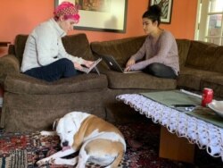 On-campus college life has been suspended for both my daughters, sheltering at home and studying online. (Penelope Poulou/VOA)