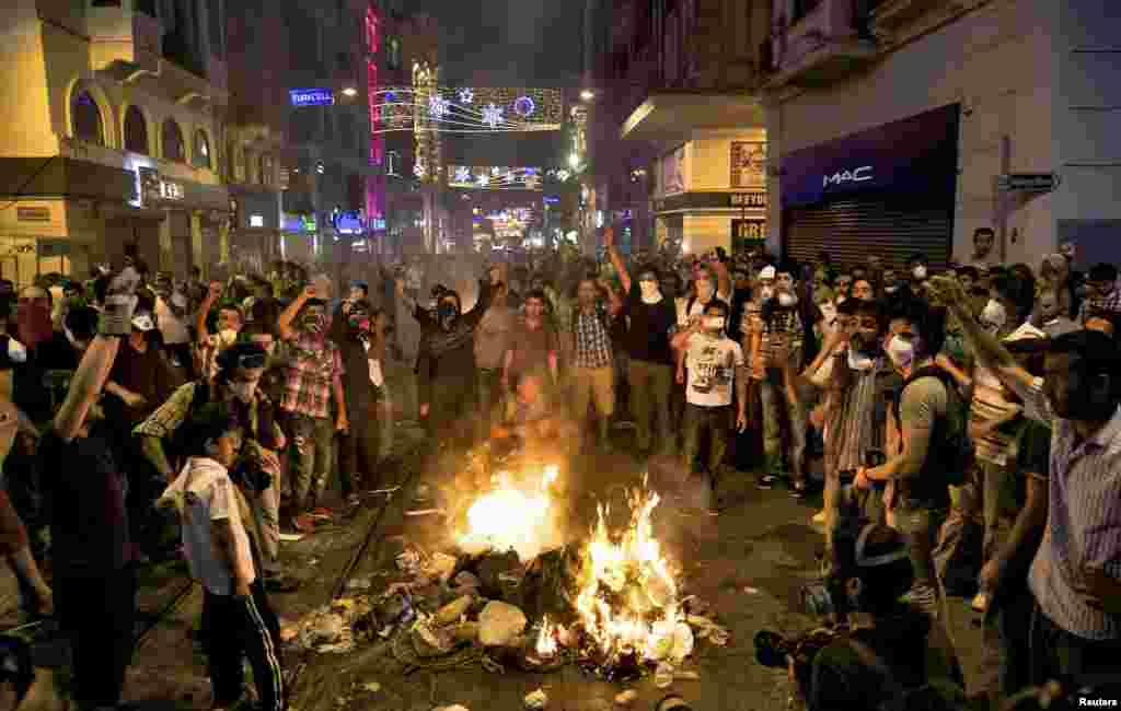 Protesters shout slogans as they block the main Istiklal street in central Istanbul, late July 8, 2013.