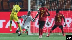 FILE: Zimbabwe's Khama Billiat, left, scores his side's opening goal during the group A soccer match between Uganda and Zimbabwe at the Africa Cup of Nations at Cairo International Stadium in Cairo, Egypt, Wednesday, June 26, 2019. (AP Photo/Hassan Ammar)