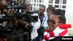 FILE - Zimbabwe's Lawyers For Human Rights (ZLHR) Board Member Beatrice Mtetwa speaks to the media outside the High Court after she was granted a $500 bail in Harare, March 25, 2013. 