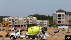 This photo taken Monday, July 1, 2019 shows new construction underway at Carraway Village, a mixed-use community in Chapel Hill, N.C. (AP Photo/Gerry Broome)