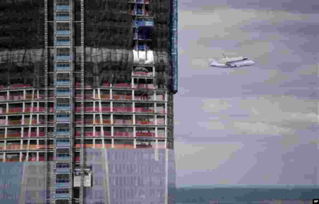 Space shuttle Enterprise, riding on the back of the NASA 747 Shuttle Carrier Aircraft, flies past the World Trade Center construction on Friday, April 27, 2012 in New York. Enterprise is eventually going to make its new home in New York City at the Intr