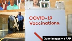 A sign points to a vaccination site set up inside Union Station on June 10, 2021, in Los Angeles, California.